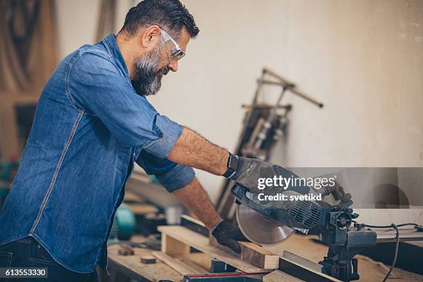 carpenter at his happy place - table saw stock pictures, royalty-free photos & images