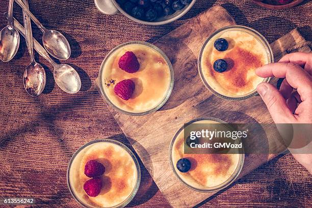 preparing homemade creme brulee with berries - flan stock pictures, royalty-free photos & images