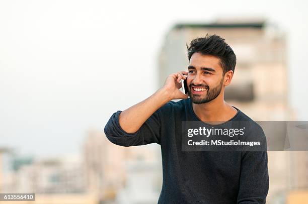 handsome man talking on mobile phone. - handsome indian guys stock pictures, royalty-free photos & images