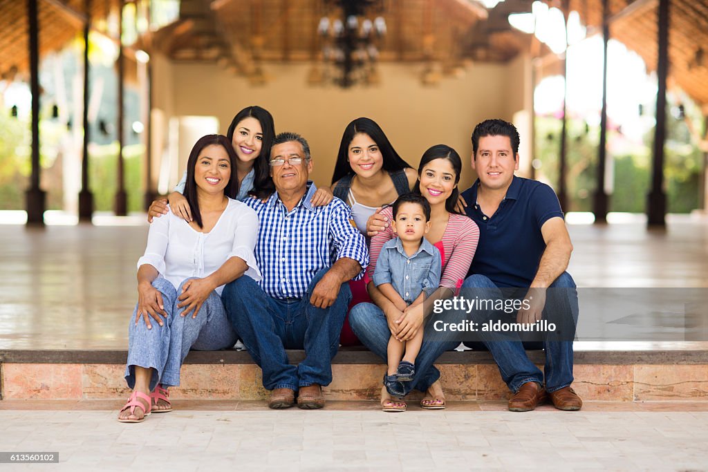Large family sitting and smiling at the camera