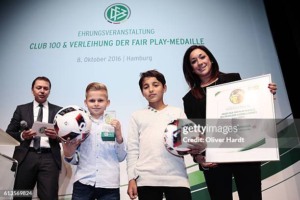 Fair Play medal winner Janne Weinreich poses Mohammed and Nadine Kessler during Club 100 & Fair Ist Mehr - Awarding Ceremony at Curio Haus on October...