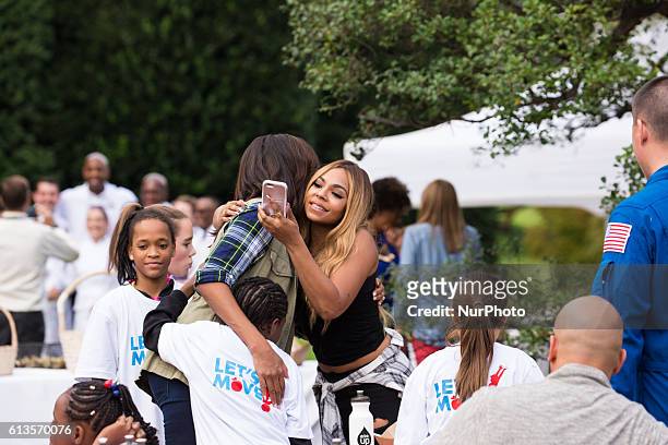 On Thursday, Oct. 6, First Lady Michelle Obama hugs Ashanti, and students as she says goodbye, after her final Fall Harvest from the White House...