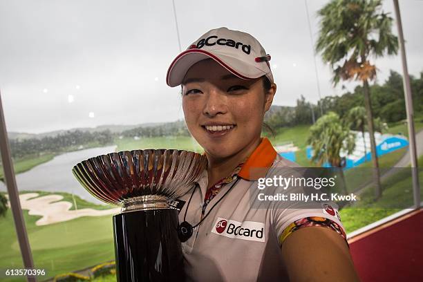 Ha Na Jang pretends to take a selfie while holding the trophy after winning the competition in the Fubon Taiwan LPGA Championship on October 9, 2016...