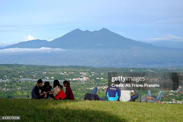 local tourists are watching dramatic sky over top of mt salak in early morning. puncak pass, west java. 1 hour from bogor city. - puncak pass stock pictures, royalty-free photos & images
