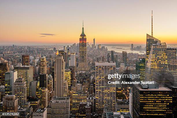 new york city skyline with illuminated skyscrapers seen from above during sunrise, new york state, usa - staat new york bildbanksfoton och bilder