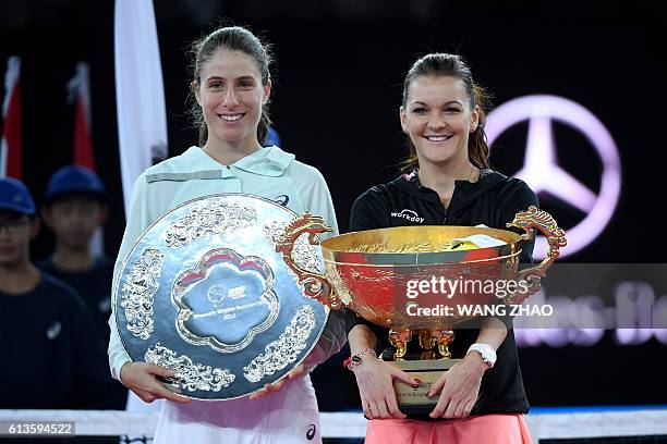 Agnieszka Radwanska of Poland poses with runner-up Johanna Konta of Britain during the awards ceremony after the women's singles final of the China...
