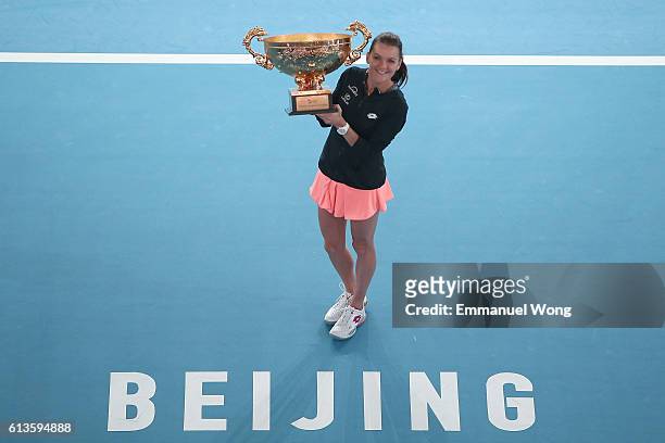 Agnieszka Radwanska of Poland poses with her trophy after winning the the Womens's singles final match against Johanna Konta of Great Britain on day...