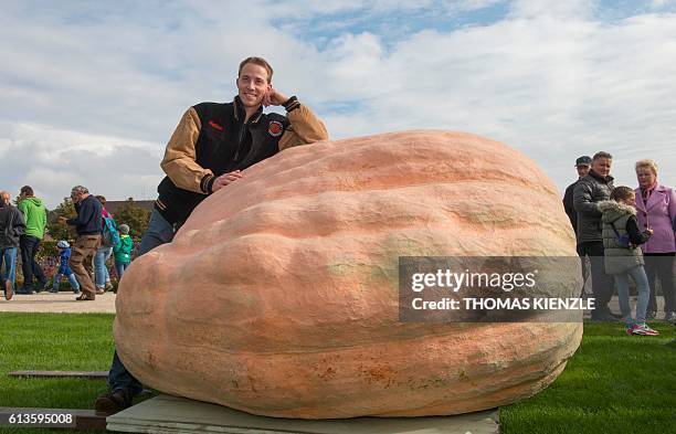 Belgian Mathias Willemijns poses with his atlantic giant pumpkin prior the weight-off at the Giant Pumpkin European Championship in Ludwigsburg,...