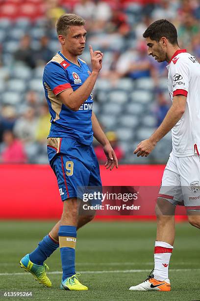 Aleksandr Kokko of the Jets has a disagreement with Iacopo La Rocca of Adelaide during the round one A-League match between the Newcastle Jets and...