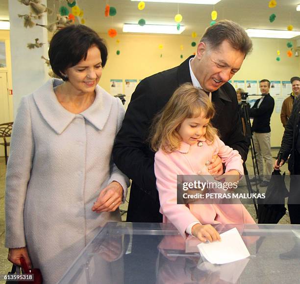 Lithuanian Prime Minister and leader of the Lithuanian Social Democratic Party Algirdas Butkevicius and his wife cast their ballot at a polling...