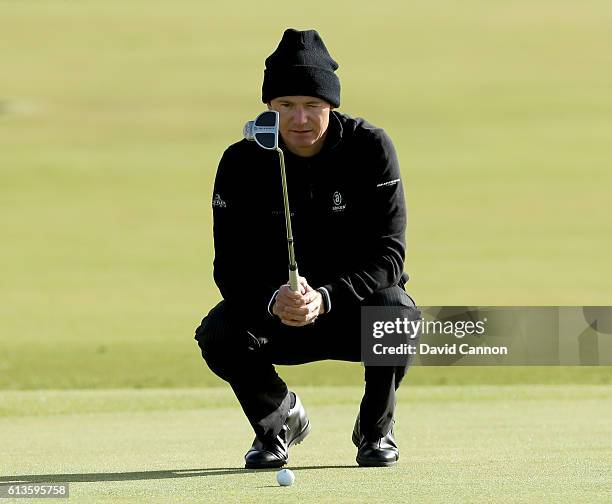 Lasse Jensen of Denmark lines up a putt on the first green during the final round of the Alfred Dunhill Links Championship at The Old Course on...