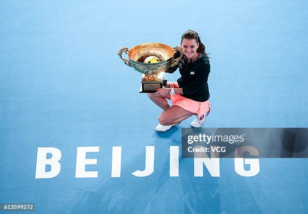 Agnieszka Radwanska of Poland holds the winners trophy after winning the Women's Singles final against Johanna Konta of Great Britain on day nine of...