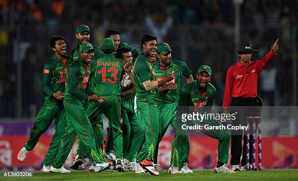 Bangladesh fielders celebrate the wicket England captain Jos Buttler during the 2nd One Day International match between Bangladesh and England at...