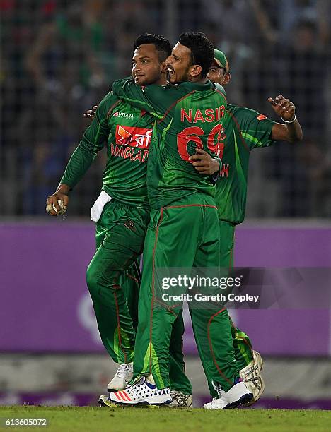 Shakib Al Hasan of Bangladesh celebrates with Nasir Hossain after catching out Moeen Ali of England during the 2nd One Day International match...