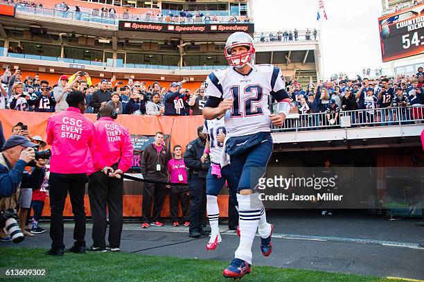 Quarterback Tom Brady of the New England Patriots runs onto the field prior to the game against the Cleveland Browns at FirstEnergy Stadium on...