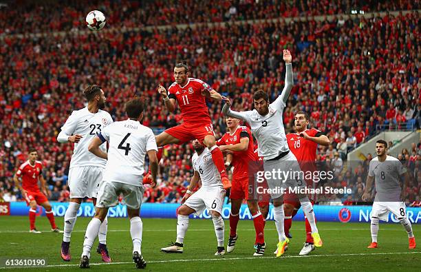 Gareth Bale of Wales jumps to head the opening goal during the FIFA 2018 World Cup Qualifier Group D match between Wales and Georgia at Cardiff City...