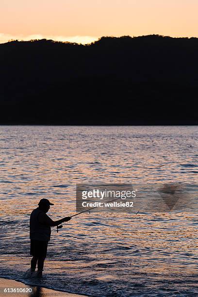 silhouette of a tico fishing - península de nicoya fotografías e imágenes de stock