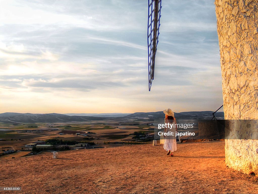 Pretty woman  looking at the Windmills at sunset