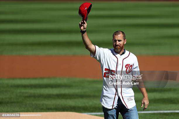 Former MLB player Adam LaRoche throws out the ceremonial first pitch prior to game two of the National League Division Series between the Los Angeles...
