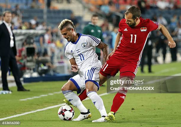 Liechtenstein's defender Franz Burgmeier tries to tackle Israel's forward Maor Buzaglo during the World Cup 2018 qualification football match between...