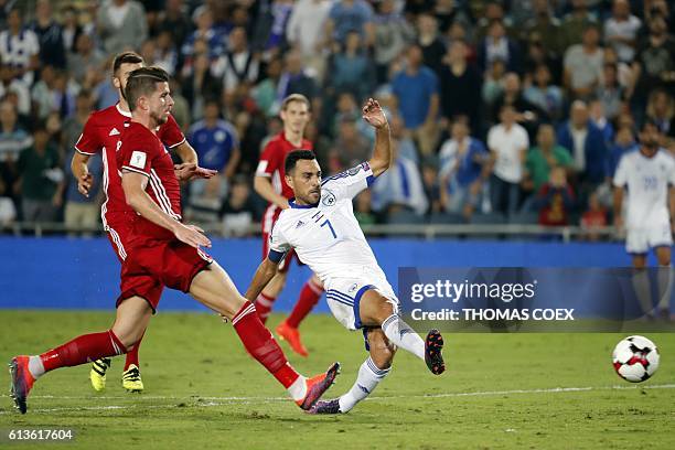 Israel's midfielder Eran Zahavi passes the ball as Liechtenstein's midfielder Sandro Wieser defends during the World Cup 2018 qualification football...