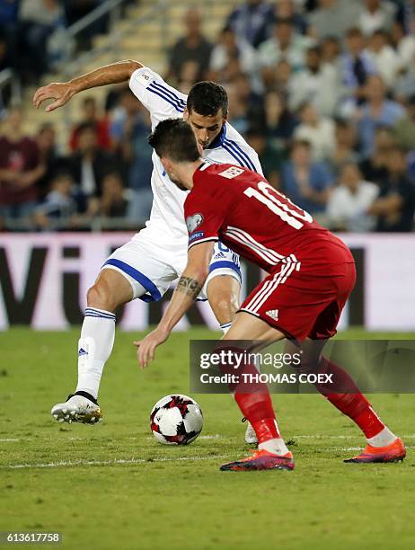 Israel's forward Tomer Hemed controls the ball as Liechtenstein's midfielder Sandro Wieser defends during the World Cup 2018 qualification football...