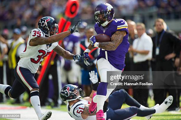 Matt Asiata of the Minnesota Vikings pushes away Eddie Pleasant of the Houston Texans after catching the ball for 23 yards on October 9, 2016 at US...