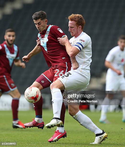 Alex Jones of Port Vale contests the ball with Dean Lewington of Milton Keynes Dons during the Sky Bet League One match between Milton Keynes Dons...