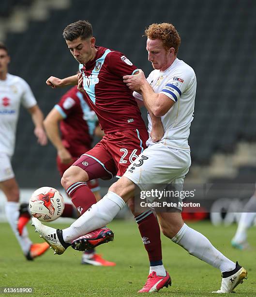 Alex Jones of Port Vale contests the ball with Dean Lewington of Milton Keynes Dons during the Sky Bet League One match between Milton Keynes Dons...