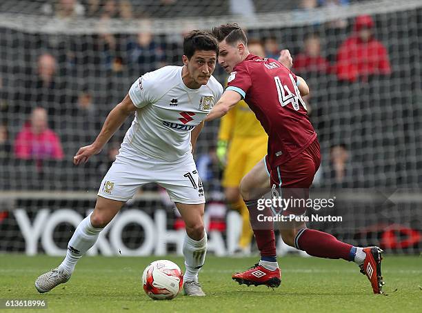 George B Williams of Milton Keynes Dons controls the ball under pressure from Sam Hart of Port Vale during the Sky Bet League One match between...