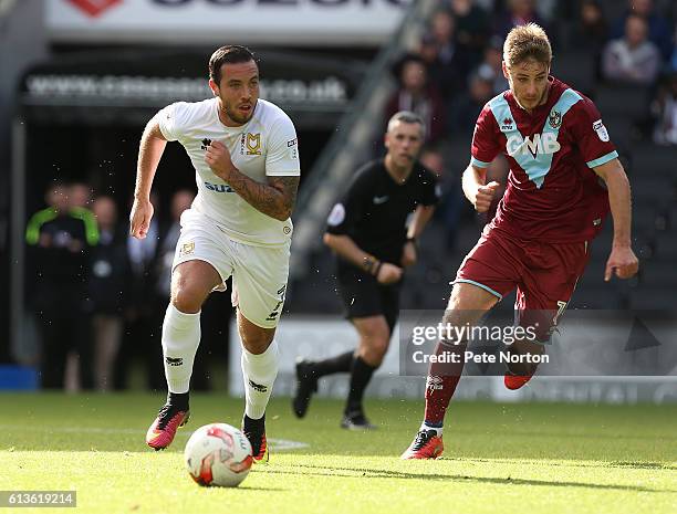 Samir Carruthers of Milton Keynes Dons moves forward with the ball away from Sam Foley of Port Vale during the Sky Bet League One match between...