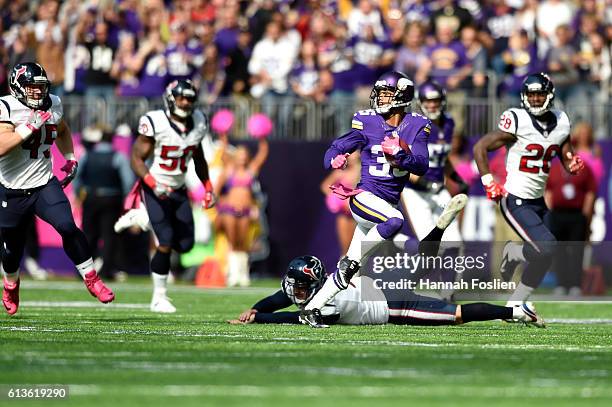 Marcus Sherels of the Minnesota Vikings breaks a tackle from punter Shane Lechler of the Houston Texans while returning a punt 79 yards for a...