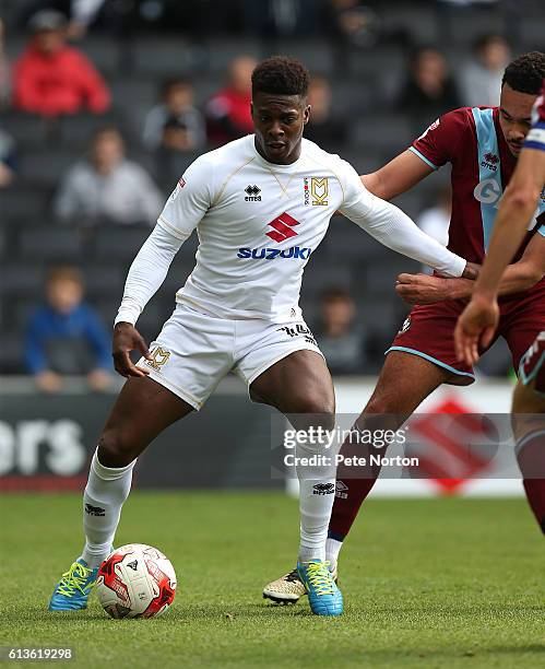 Kieran Agard of Milton Kenes Dons controls the ball under pressure from Remie Streete of Port Vale during the Sky Bet League One match between Milton...