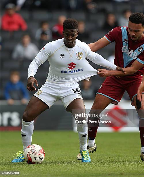 Kieran Agard of Milton Kenes Dons controls the ball under pressure from Remie Streete of Port Vale during the Sky Bet League One match between Milton...