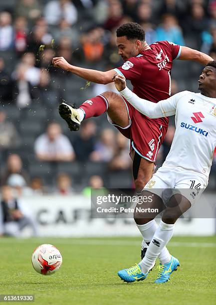 Remie Streete of Port Vale attempts to clear the ball under pressure from Kieran Agard of Milton Keynes Dons during the Sky Bet League One match...