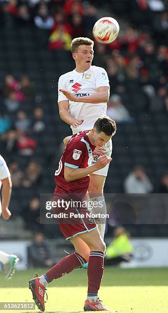 Paul Downing of Milton Keynes Dons rises to head the ball away from Sam Hart of Port Vale during the Sky Bet League One match between Milton Keynes...