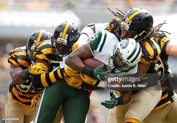 Matt Forte of the New York Jets rushes against Jarvis Jones, Vince Williams and Mike Mitchell of the Pittsburgh Steelers in the first half during the...