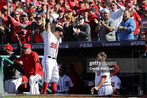 Jose Lobaton of the Washington Nationals receives a curtain call after hitting a three run home run against the Los Angeles Dodgers in the fourth...