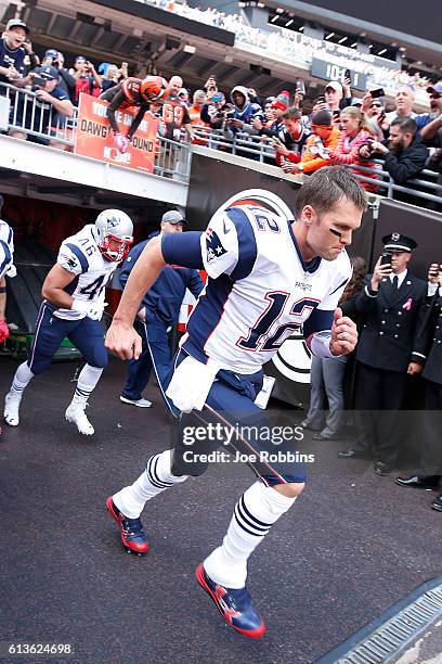 Tom Brady of the New England Patriots runs onto the field before the game against the Cleveland Browns at FirstEnergy Stadium on October 9, 2016 in...