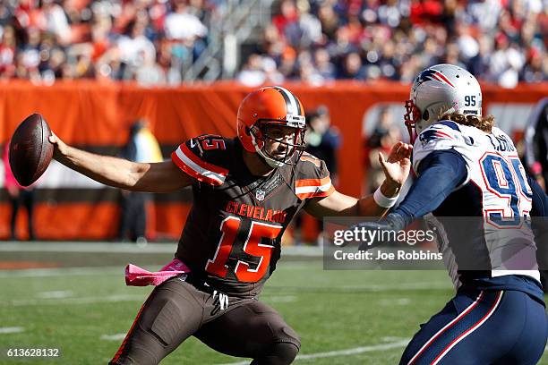 Charlie Whitehurst of the Cleveland Browns tries to avoid pressure from Chris Long of the New England Patriots in the fourth quarter of the game at...