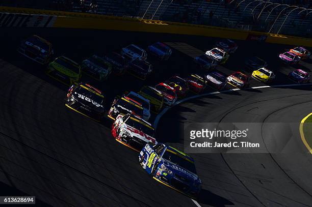 Jimmie Johnson, driver of the Lowe's Chevrolet, leads a pack of cars during the NASCAR Sprint Cup Series Bank of America 500 at Charlotte Motor...