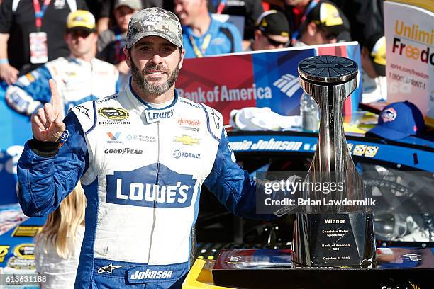 Jimmie Johnson, driver of the Lowe's Chevrolet, celebrates in victory lane after winning the NASCAR Sprint Cup Series Bank of America 500 at...