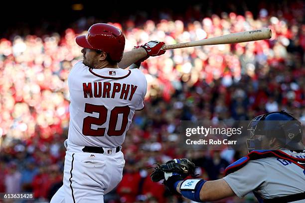 Daniel Murphy of the Washington Nationals hits an RBI single in the seventh inning against the Los Angeles Dodgers during game two of the National...