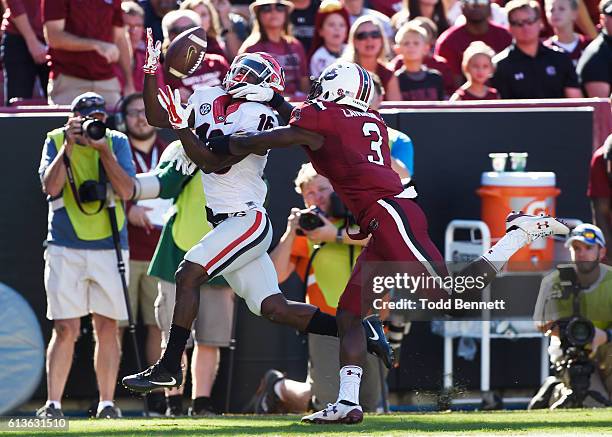 Defensive back Chris Lammons of the South Carolina Gamecocks breaks up a pass intended for wide receiver Isaiah McKenzie of the Georgia Bulldogs...
