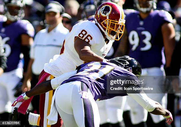 Washington Redskins tight end Jordan Reed stiff arms Baltimore Ravens free safety Lardarius Webb during a match between the Baltimore Ravens and the...