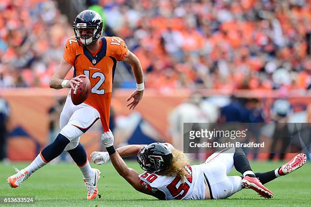 Linebacker A.J. Hawk of the Atlanta Falcons attempts to tackle quarterback Paxton Lynch of the Denver Broncos in the first half of the game at Sports...