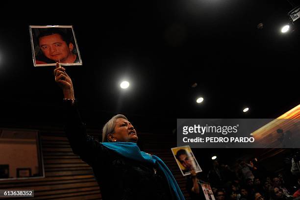 Yolanda Moran holds a picture of her missing son Dan Jeremeel Fernandez, who disappeared on December 19, 2008 in Torreon, Coahuila, as she attends...