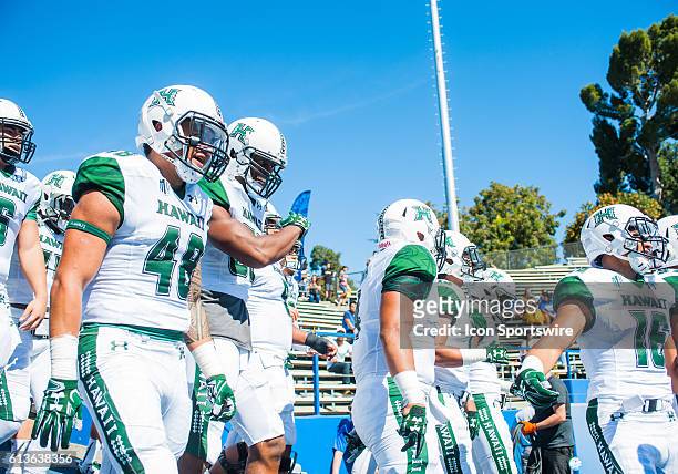 Hawaii Warriors players march onto the field prior to the Mountain West Conference game between San Jose State Spartans verses the Hawaii Warriors at...