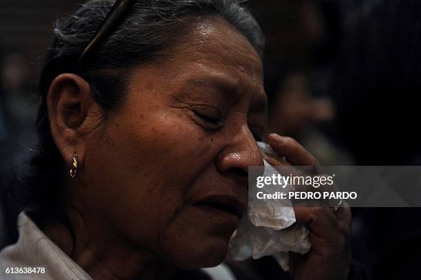 Woman cries during the presentation of the independent inquiry into the massacre of 72 migrants in San Fernando, Tamaulipas in August 2010 and the...