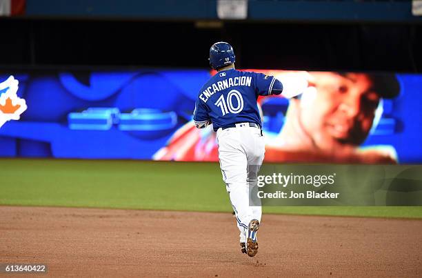 Edwin Encarnacion of the Toronto Blue Jays rounds the bases after hitting a two-run home run in the bottom of the first inning of Game 3 of the ALDS...